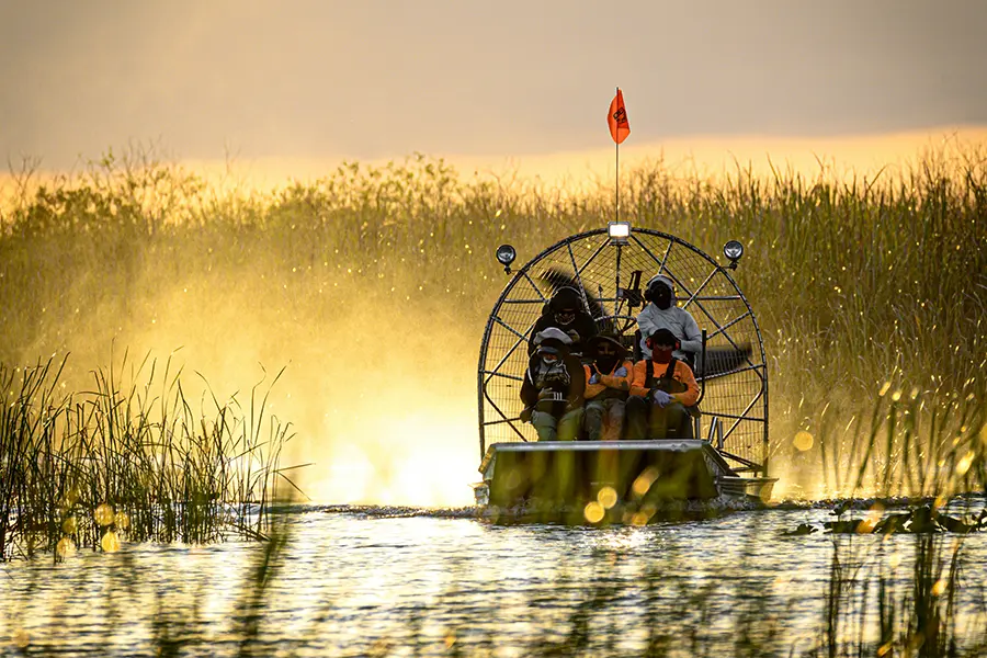 Family riding an Everglades airboat tour in Florida.