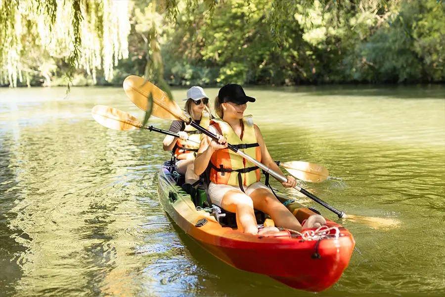 Mother and daughter kayaking on a calm Florida estuary.