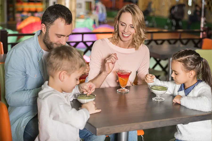 Young family enjoying drinks at a cafe in Naples, Florida.